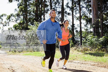 Young couple jogging in forest Young couple jogging in forest