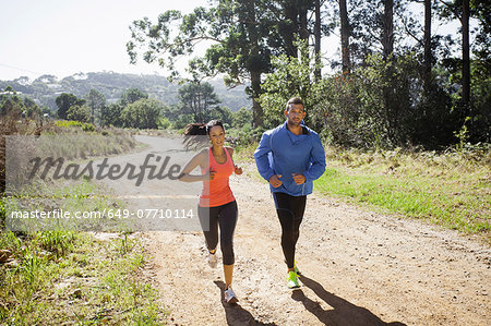 Young couple jogging in forest