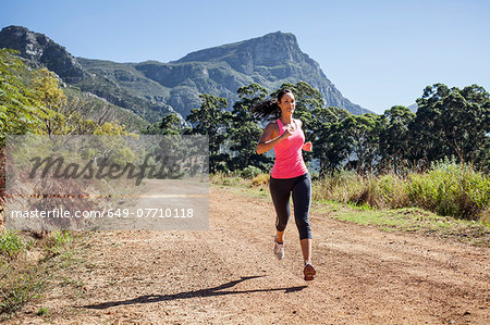 Young woman jogging in forest