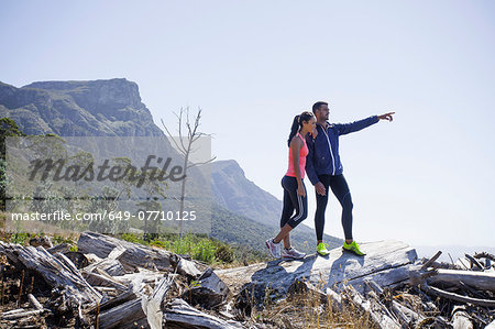 Young joggers enjoying view from hilltop