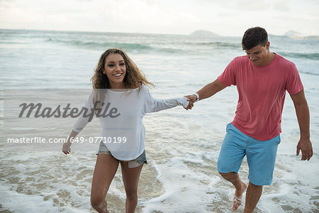 Young couple paddling in sea, Ipanema Beach, Rio de Janeiro, Brazil