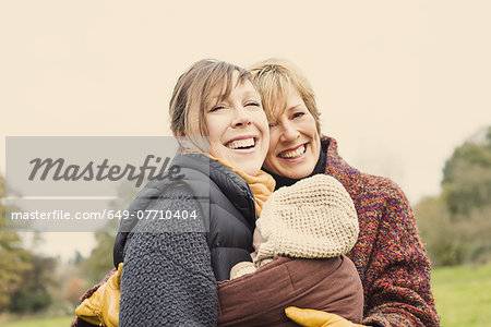 Mother with baby and grandmother laughing