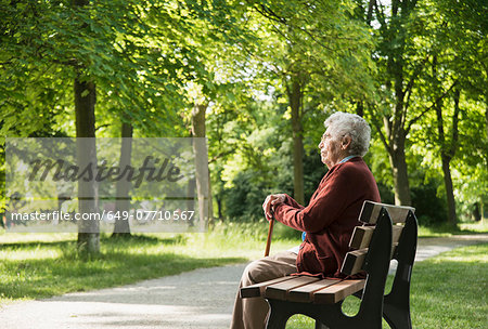 Senior woman sitting on park bench