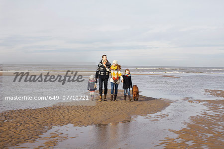 Mid adult parents with son, daughter and dog strolling on beach, Bloemendaal aan Zee, Netherlands