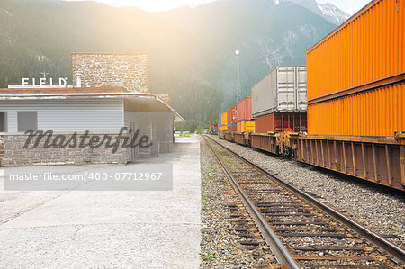 Freight train departs from Field station. Canadian rockies.