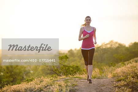 Young Beautiful Woman Running on the Mountain Trail in the Morning. Active Lifestyle