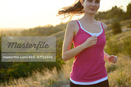 Young Beautiful Woman Running on the Mountain Trail in the Morning. Active Lifestyle