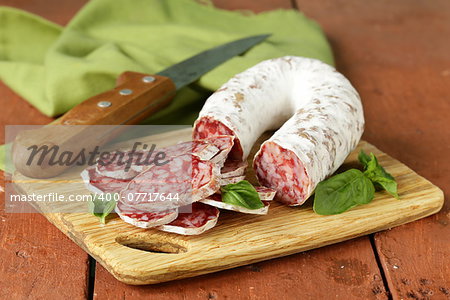 delicacy smoked sausage (salami) on a wooden board