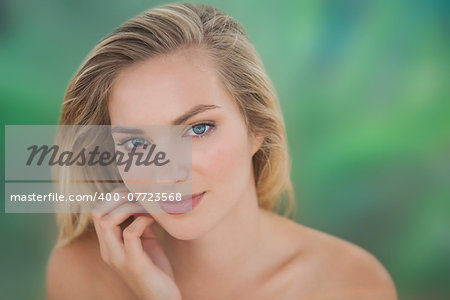 Beautiful natural blonde looking at camera on blue and green background