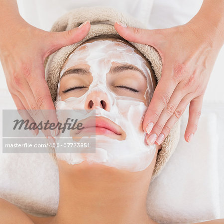 Close-up of an attractive young woman receiving treatment at spa center