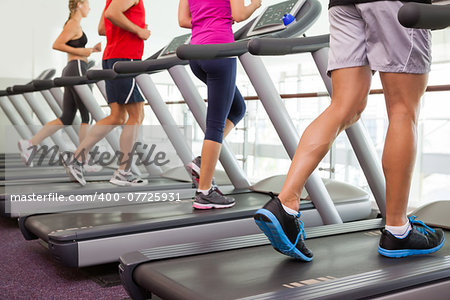 Row of people on treadmills at the gym