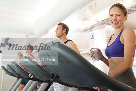 Row of people working out on treadmills at the gym