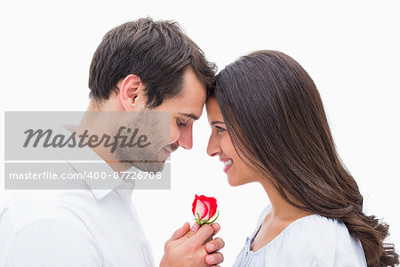 Handsome man offering his girlfriend a rose on white background