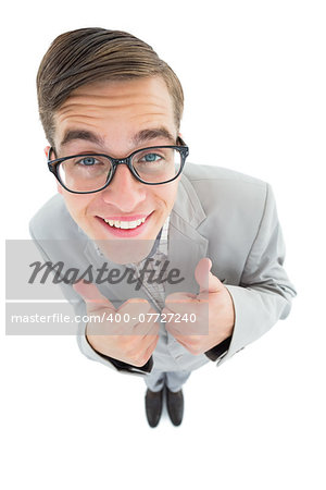 Geeky hipster smiling at camera with thumbs up on white background
