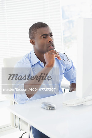 Thoughtful businessman working at his desk in his office