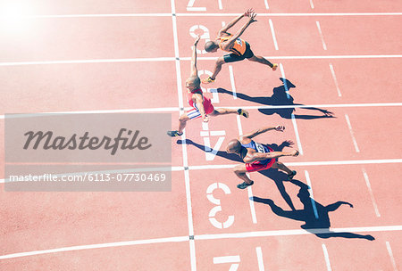 Runners crossing finish line on track