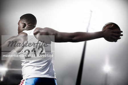 Track and field athlete throwing discus