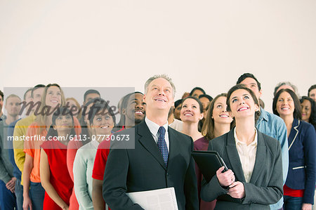 Crowd of business people looking up