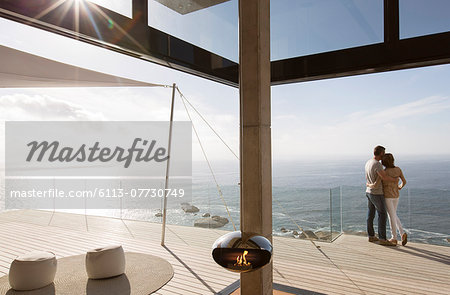 Couple standing on balcony of modern home