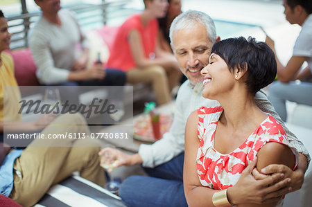 Couple hugging at party