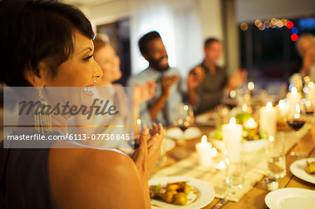 Friends applauding at dinner party