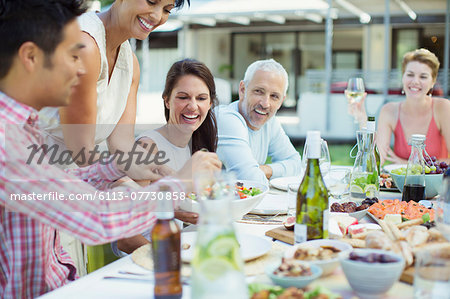 Woman serving friends at party Woman serving friends at party