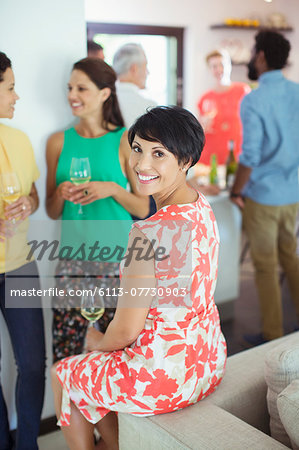 Woman smiling on sofa at party