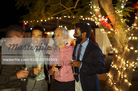 Men talking at party Men talking at party