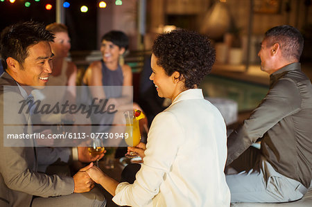 Couple holding hands at party