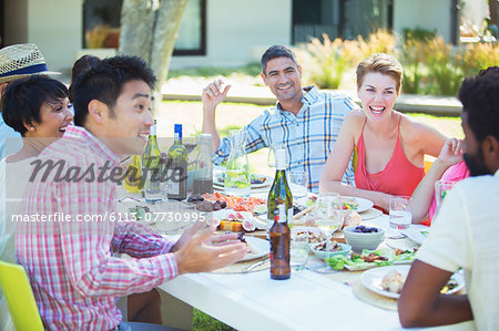 Friends talking at table outdoors
