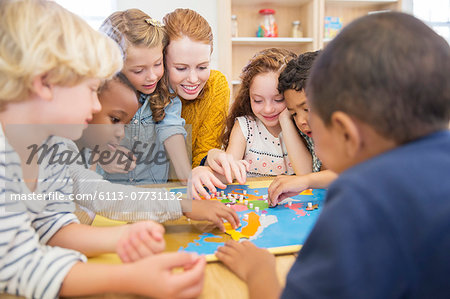 Teacher playing with students in classroom