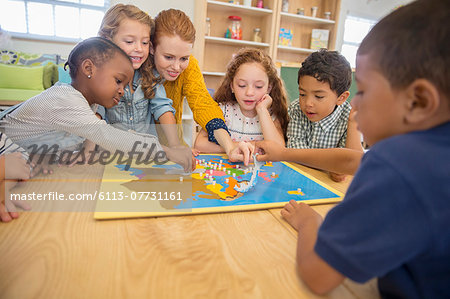 Children and teacher playing in class