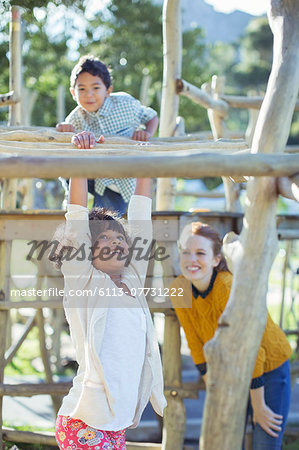 Teachers and students playing on play structure