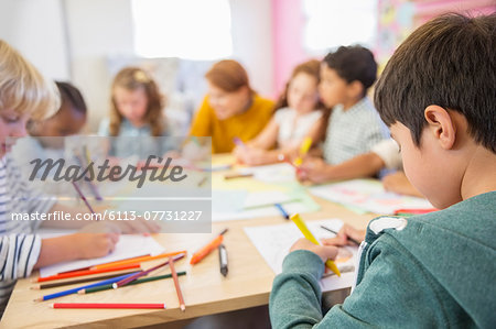 Teacher and students drawing in classroom Teacher and students drawing in classroom