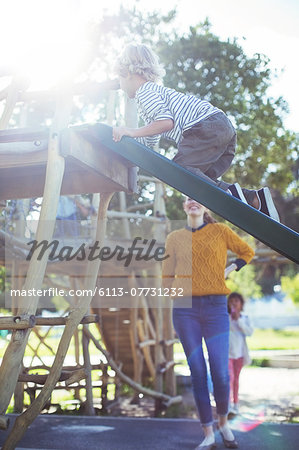 Teacher watching student play on play structure