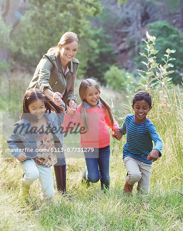 Students and teacher walking in field