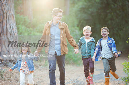 Students and teacher walking in forest