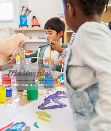 Students painting in classroom