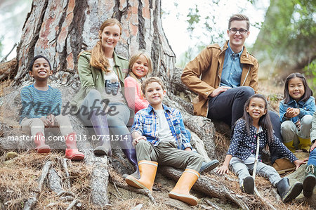 Students and teachers smiling in forest