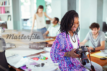 People reviewing photos in office