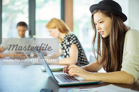 People working at conference table in office