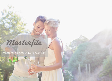 Couple drinking champagne outdoors