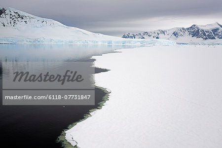 View from above, of melting sea ice off the shores of islands in Antarctica.