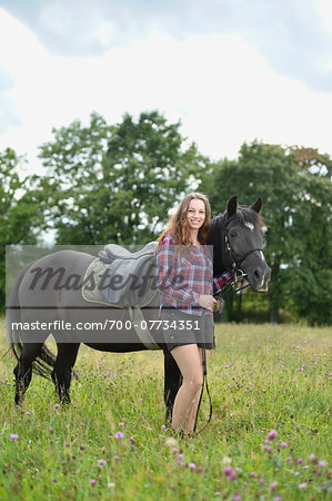 Close-up portrait of a young woman with a Arab-Haflinger horse in a meadow in summer, Upper Palatinate, Bavaria, Germany