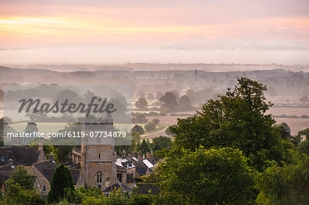 St. Lawrence Church and misty sunrise, Bourton-on-the-Hill, Gloucestershire, The Cotswolds, England, United Kingdom, Europe