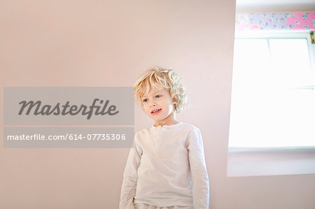 Portrait of four year old boy in bedroom