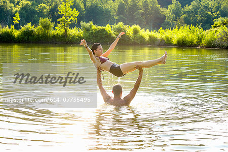 Young couple fooling around in canal, Delaware Canal State Park, New Hope, Pennsylvania, USA