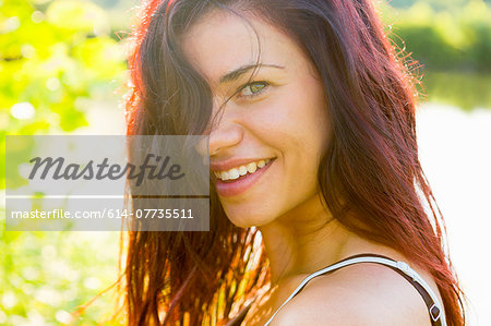 Portrait of young woman with hair hiding face