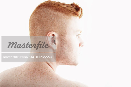 Rear view studio portrait of young man