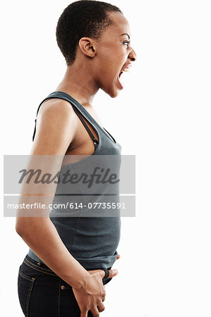 Studio shot of young woman shouting